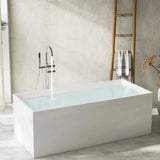 A modern white bathtub in a stylish bathroom setting with natural light and decor elements.