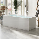 A modern bathroom scene featuring a minimalist white bathtub with a sleek faucet and greenery in the background.