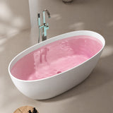 A modern oval bathtub with clear water in a stylish bathroom setting.