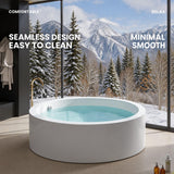 A modern bathtub in a serene outdoor setting surrounded by snowy mountains.