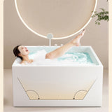 A person relaxing in a stylish bathtub with ambient lighting.
