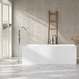 A modern bathroom setting featuring a freestanding bathtub and a sleek wall-mounted faucet.