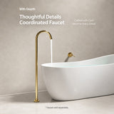 A modern bathtub with a stylish faucet setup in a minimalist bathroom setting.