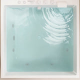A top view of a white bathtub filled with clear water, showcasing its features and structure.