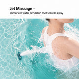 A person enjoying a water massage in a spa-like setting with flowing water.
