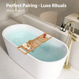 A modern bathtub styled with a wooden tray holding items, set in a serene bathroom environment.