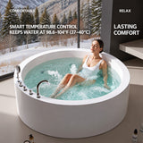 A woman relaxing in a modern round bathtub with a mountainous view in the background.