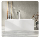 A modern white bathtub in a minimalistic bathroom setting with a wooden ladder and decorative vase.