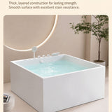 A modern square bathtub in a minimalistic bathroom setting.