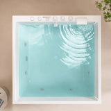A top-down view of a modern double bathtub with water and air jets.
