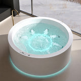 A modern round bathtub with illuminated edges set in a stylish room by a window.