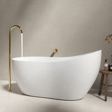 A modern white freestanding bathtub with a gold faucet, set against a neutral wall.