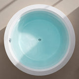 A top view of a round bathtub showcasing its clean lines and turquoise water.