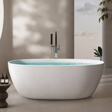 A sleek, modern white bathtub displayed in a softly lit room with minimal decor.