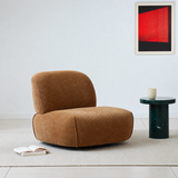 Brown chenille armless swivel chair in a bright room with green marble table and red art