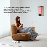 Woman lounging on a brown upholstered swivel barrel chair in a bright room, seat depth marked 24.0"/61cm