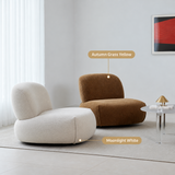 Cream and autumn yellow armless upholstered lounge chairs on a rug in a bright room