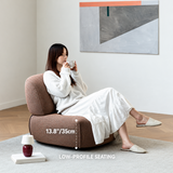 Woman sipping a drink in a brown chenille barrel chair, seat height 13.8"/35cm, bright room