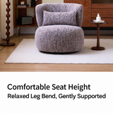 Mottled lilac swivel barrel chair with lumbar pillow on a cream rug, set before a wood cabinet and side table with text below