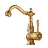 Gold-tone vintage kitchen faucet with carved floral band and rosette lever handle, shown on a plain white background.