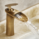 Copper vintage kitchen faucet with a waterfall-style water output, showcasing a sleek design and shiny finish.