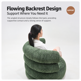 Rear view of a green textured swivel barrel chair with a woman seated, white studio backdrop