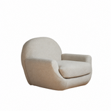 Beige upholstered swivel barrel chair angled on a white studio background