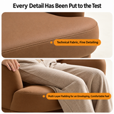 Close-up of a camel-brown swivel barrel chair's armrest stitching with legs on the padded seat.