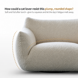 Close-up of a cream bouclé swivel barrel chair arm and rounded side with dashed contour lines