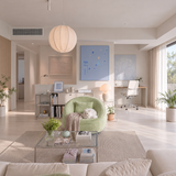 Pale green swivel barrel chair with white cat, blue artwork and paper lantern in sunlit living room
