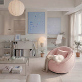 Pink bouclé swivel barrel chair with pillow and throw, white cat curled on the seat in a bright living room