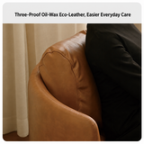 Close-up of tan leather-look barrel chair arm and stitched seam beside a person in black