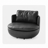 Black leather-look swivel barrel chair on a white studio background