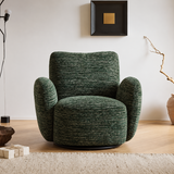 Green textured swivel barrel chair on a black base, front view in a bright room with wood floor and rug