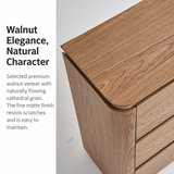 Warm brown wood-grain sideboard close-up with rounded top edge and visible drawers