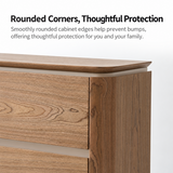 Close-up of a warm wood-grain sideboard with rounded top edge and drawer fronts