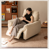 Cream upholstered swivel recliner chair with a woman seated in a warm living room