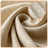 Close-up of beige woven swivel barrel chair fabric with a magnified weave inset