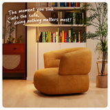 Ochre chenille swivel barrel chair beside a wooden cabinet and bookshelf in a warm room