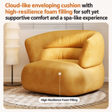 Ochre-yellow barrel chair on a fringed rug beside a tall floor lamp, with a pointer label on the seat cushion
