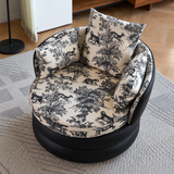 High-angle view of a cream and black toile-pattern swivel barrel chair with two cushions on a gray rug
