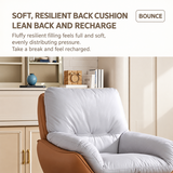 Close-up of a tan swivel barrel chair's plush light gray back cushion and arms in a bright cream room
