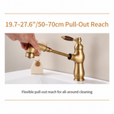 Brushed brass kitchen faucet with wood-grain handle, hand pulling spray head out on a spring hose, 19.7-27.6"/50-70cm reach