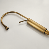 Antique brushed brass kitchen faucet with a high-arc spout and side lever on a smooth, light background.