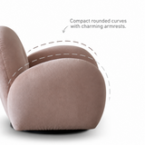 Detail view of a dusty pink velvet swivel barrel chair's rounded arm and curved back with dashed arc overlay on white
