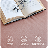 Close-up of dark pink velvet upholstery texture with an open book and glasses, plus fabric feature icons.
