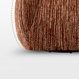 Close-up of rust-brown ribbed chenille on a swivel barrel chair, curved side edge with dashed outline on white
