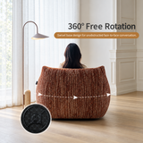 Rust-brown ribbed barrel chair back with seated person, floor lamp, swivel base inset