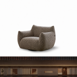 Taupe textured swivel barrel chair on white above a dark modern interior scene