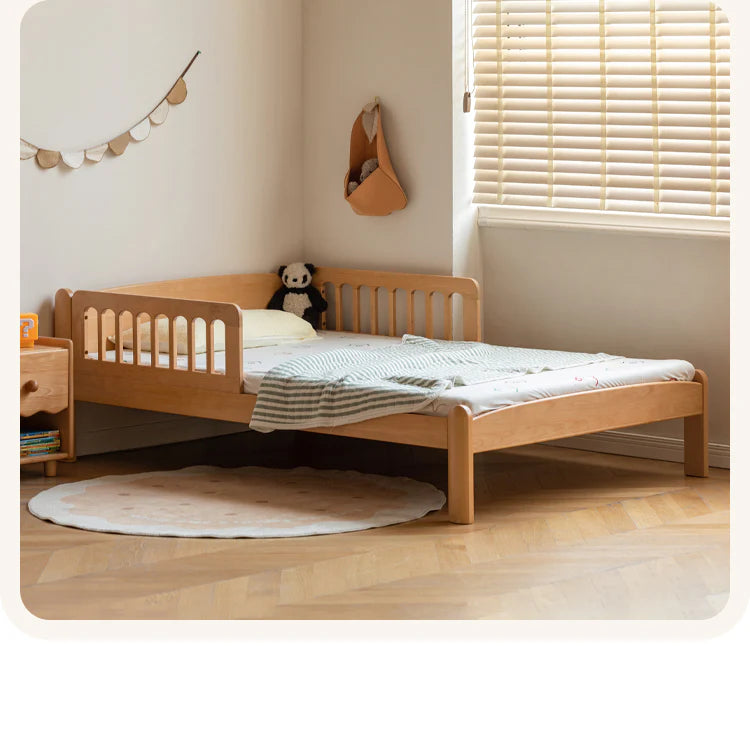 Beech solid wood children's bunk bed with a low profile, placed in a bright room featuring a round rug and wall decor